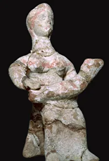 Greek terracotta statuette of a woman with a baby