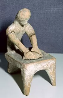 Greek terracotta of a woman making bread