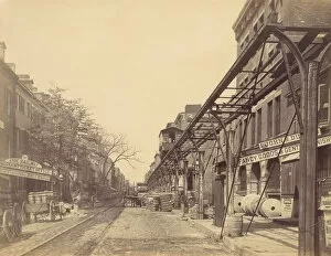 Elevated Railway Gallery: Greenwich Street, New York City, with Office of Erie Railway, 1870s. Creator: Unknown