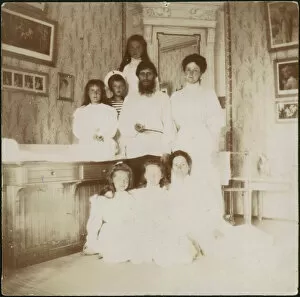 Grigory Rasputin with Empress Alexandra Fyodorovna, her five children and seated right governess Mar