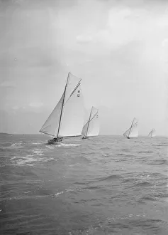 Stern View Prints: Group of 8 Metres sailing yachts racing downwind, 1913. Creator: Kirk & Sons of Cowes