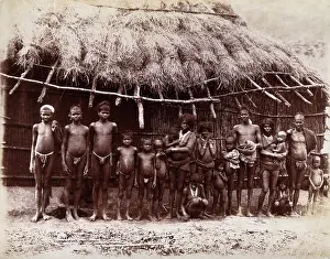 Mumbai Maharashtra India Prints: A group of adults and children standing in a line outside a bamboo hut with a thatched
