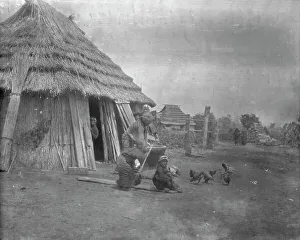 Ethnic Prints: Group of Ainu outside a hut, 1908. Creator: Arnold Genthe