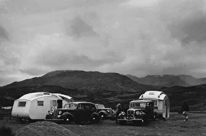 Group of cars and caravans camping in Scottish Highlands 1930 s. Creator: Unknown