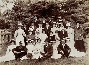 Sitting On Ground Prints: A group of hospital staff, including nurses wearing matching straw hats