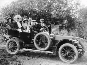 Spare Tyre Prints: A group of men and women taking an outing in a 1907 Mercedes, 1908