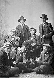 Game Collection: Group photo of men with musical instruments and playing cards, 1915. Creator: Unknown