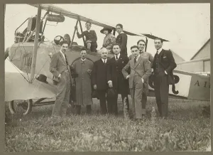 Aviator Prints: Group portrait in front of plane, 1915-1930. Creator: Fedele Azari