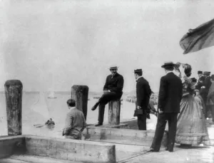 Group of well-dressed people on dock during yacht race, Oyster Bay, Long Island, N.Y. 1905. Creator: Frances Benjamin Johnston