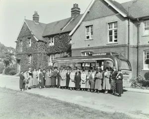 Respectable Prints: Group of women visitors in front of a school, Croydon, 1937