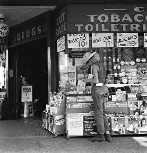 Straw Hat Collection: Half-grown farm boy on main drugstore corner in town, Medford, Oregon, 1939. Creator: Dorothea Lange