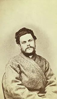 Half-length portrait of a man, dressed in convict clothing, facing front, between 1880 and 1886. Creator: Unknown