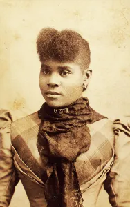 Afro Prints: Half-portrait of young woman wearing large lace scarf over plaid bodice