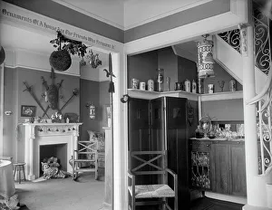 Festive Prints: Hallway with liquor cabinet and living room decorated with mistletoe ball and Christm