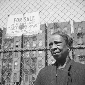 Real Estate Gallery: A Harlem resident, New York, 1943. Creator: Gordon Parks
