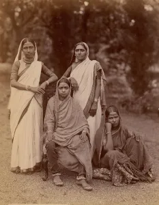 Saris Prints: Four Hindu Women, One Seated in a Chair, Outdoors, 1860s-70s. Creator: Unknown