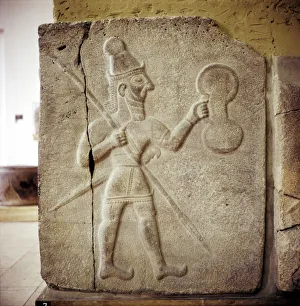 Shield Collection: Hittite relef of a Hittite warrior or war-god with shield spear and sword