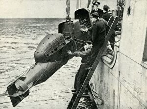 Hoisting Gallery: Hoisting a Chariot manned torpedo on board a ship, World War II, 1945. Creator: Unknown