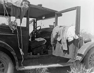 The only home of a depression-routed family of nine from Iowa, 1936. Creator: Dorothea Lange