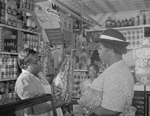 Grocers Gallery: Housewife bargaining in the store owned by Mr. J. Benjamin, Washington, D.C. 1942
