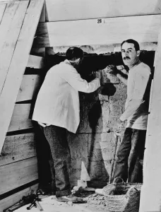 Howard Carter and a colleague excavating a tomb in the Valley of the Kings, Egypt, 1922