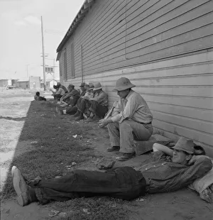 Displaced Persons Collection: Idle men seated in shade on the other side of... Tulelake, Siskiyou County, California, 1939