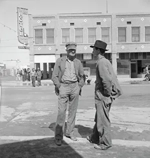 Idle pea pickers discuss prospects for work, Calipatria, Imperial Valley, California, 1939. Creator: Dorothea Lange