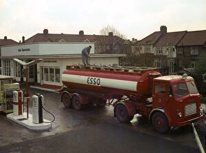 Ilford Esso petrol station with Leyland tanker making delivery 1964. Creator: Unknown