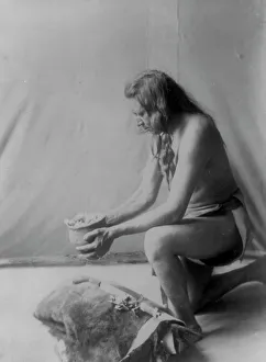 Witch Doctor Prints: Incense over a medicine bundle, c1908. Creator: Edward Sheriff Curtis