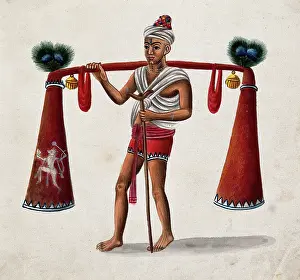 Carrying On Shoulders Prints: India: a man with a crutch carrying tubes decorated with bells
