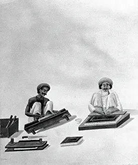 Crouching Prints: Two Indian bookbinders: one trimming page edges in a press