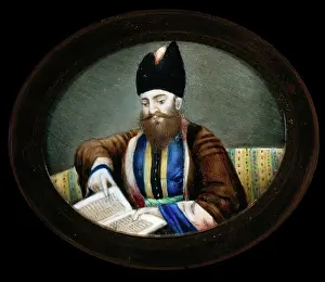 Studying Prints: An Indian (?) man seated, reading a book. Creator: Unknown