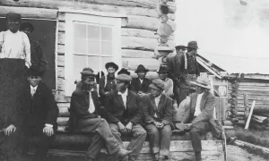 Nome Alaska United States Prints: Indigenous peoples outside of log building, between c1900 and 1916. Creator: Unknown