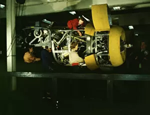 Manufacturing Gallery: Installing one of the 4 motors on the transport plane at Willow Run, between 1941 and 1945