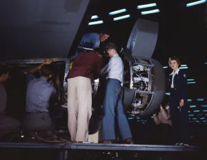Installing an engine at the Consolidated Aircraft Corporation plant, Fort Worth, Texas, 1942. Creator: Howard Hollem