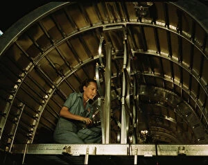 Aeronautics Gallery: Installing oxygen flask racks above the flight...Consolidated Aircraft... Fort Worth, Texas, 1942