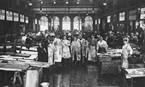 The interior of Billingsgate Market showing fishmongers and their stalls, London, c1918