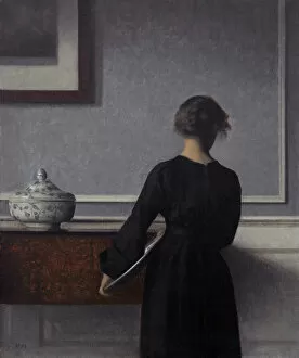 Interior with Young Woman from Behind. Artist: Hammershoi, Vilhelm (1864-1916)