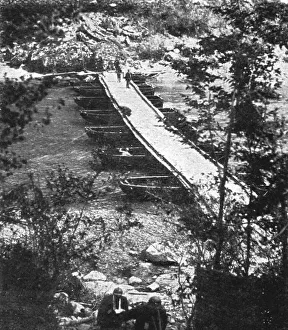 Makeshift Prints: Italian Offensive of the Isonzo; Decking is laid over the boats, 1917. Creator: Unknown