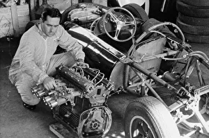 Jack Brabham inspecting the engine of a car