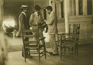 Journalist Collection: Two Japanese men and one American(?) man, probably journalists, conversing on the veranda