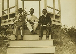 Journalist Collection: Three Japanese men, possibly journalists, seated on the steps of a gazebo, 1905. Creator: Unknown