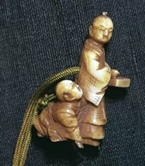 Japanese Netsuke of a man and boy at new year, 19th century