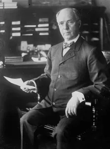Rockefeller John Davison Prints: J.D. Archbold, seated holding paper, 1911. Creator: Bain News Service