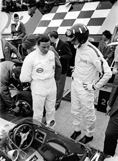 Helmet Collection: Jim Clark and Graham Hill in pits with Lotus 49 during 1967 British Grand Prix. Creator: Unknown