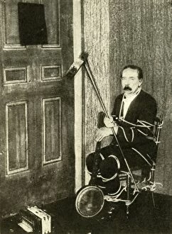 Accordion Gallery: John Nevil Maskelyne performs a spirit cabinet illusion, c1910. Creator: Unknown