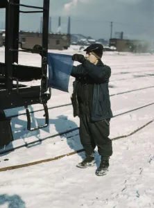 Railroad Shop Prints: John Paulinski, car inspector, blue flagging a train for inspection