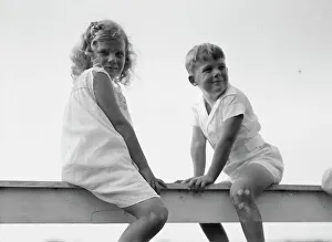 Siblings Prints: Kane children, seated on a fence, between 1911 and 1942. Creator: Arnold Genthe