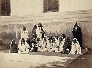 Sitting On Ground Prints: Kashmiri women in traditional dress: group portrait, c1900. Creator: Unknown