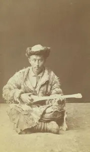 Central Asian Prints: Kazakh man, a musician with a dombra, seated, between 1870 and 1886. Creator: Unknown